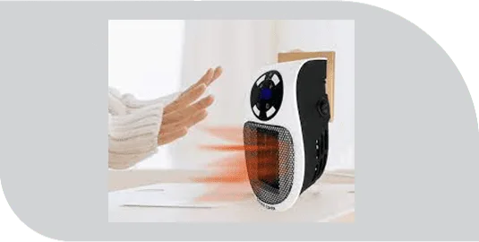 Hands warming up in front of the Ultra Air Heater as warm air flows from the grille